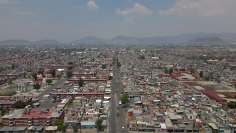 Aerial-establishing-shot-of-house-rooftops-and-cars-on-roads