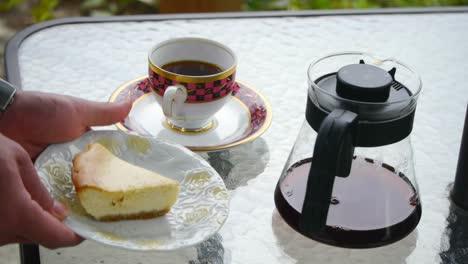 Static-shot-of-coffee-and-cheese-cake-set-placed-on-table