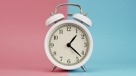 analogue white alarm clock at 01:00 on twotone background.