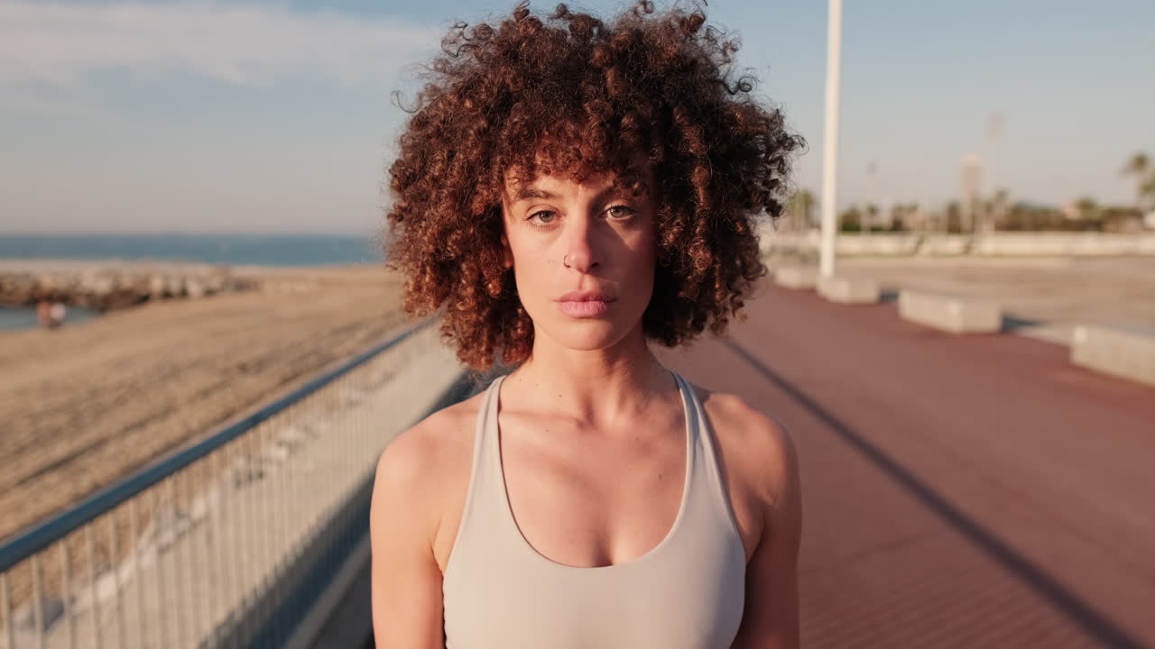 Confident Woman on Boardwalk by Beach