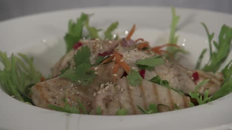 A-chef-plating-a-chicken-salad