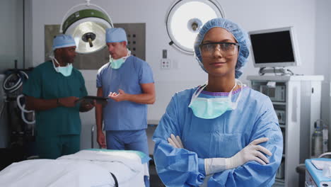 Portrait-Of-Female-Surgeon-Wearing-Scrubs-And-Protective-Glasses-In-Hospital-Operating-Theater