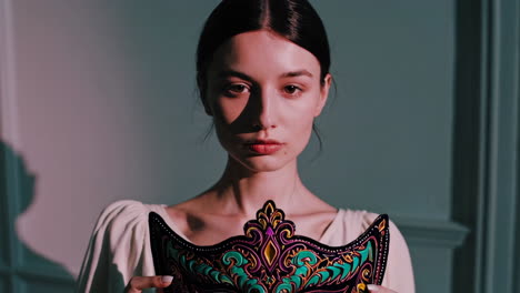 woman holding a masquerade mask