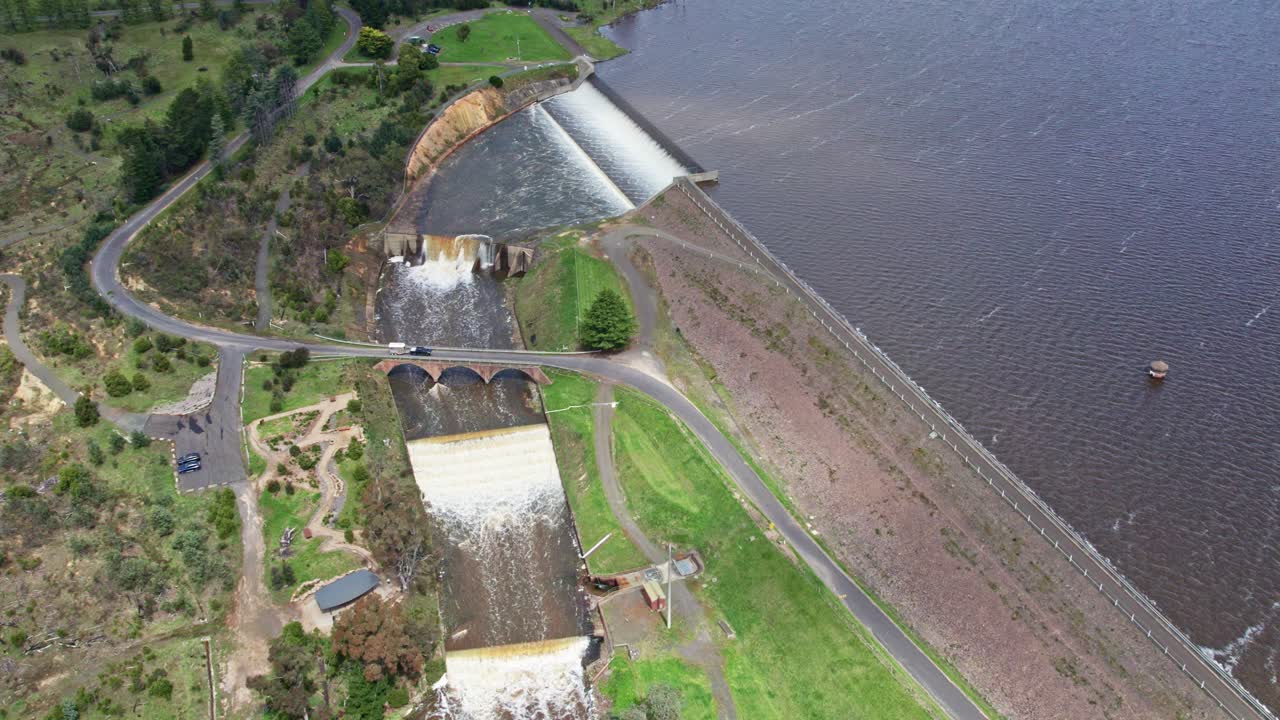 Drone view of water spilling over the Upper Coliban Reservoir spillway, central Victoria, Australia. October, 2022.