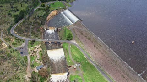drone view of water spilling over the upper coliban reservoir spillway, central victoria, australia. october, 2022.
