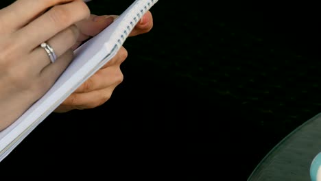 close-up of a girl writing in a notebook