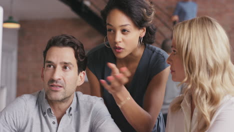 Group-of-business-people-using-computer-at-meeting