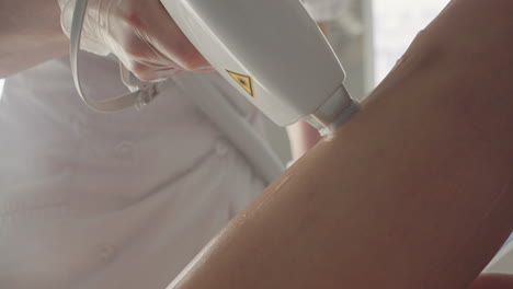 permanent-hair-removal-in-modern-beauty-clinic-aesthetician-is-using-laser-on-leg-skin-of-woman