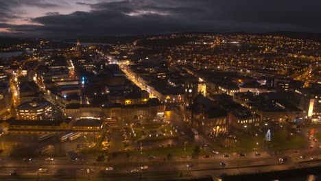 londonderry - derry - stroke city - legenderry night time aerial footage in uhd. cityscapes of the peace bridge, the foyle river, guildhall, st columb's cathedral, shipquay street, craigavon bridge