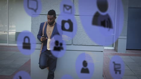multiple digital icons against african american man using smartphone on the street