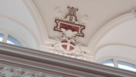 ornament-with-a-cherub-on-the-wall-of-a-large-hall