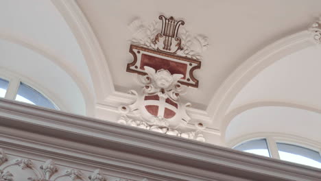 ornament with a cherub on the wall of a large hall