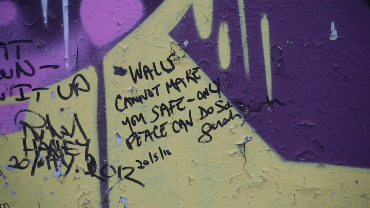 A section of wall erected to quell Northern Irish conflict, now a repository for art and messages