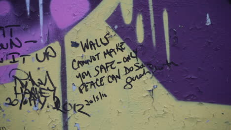 a section of wall erected to quell northern irish conflict, now a repository for art and messages