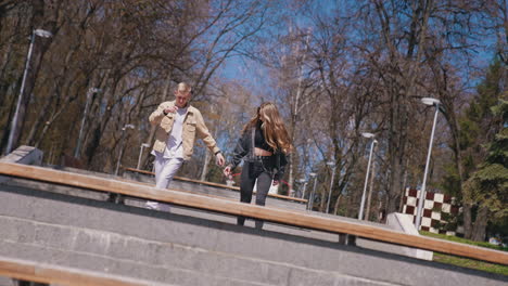 happy people spending romantic date at the bench at the park. romantic couple spending time with each other at the street. enjoying the time together concept