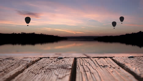 Wooden-deck-and-hot-air-balloons-over-a-lake