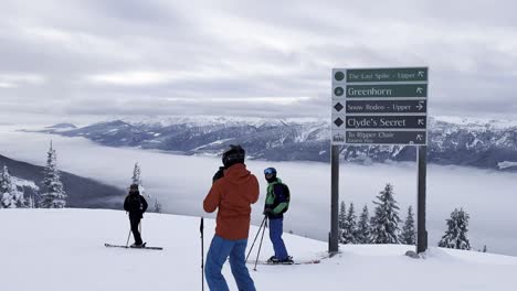 skiers over the top of mt mackenzie in the revelstoke mountain resort in canada