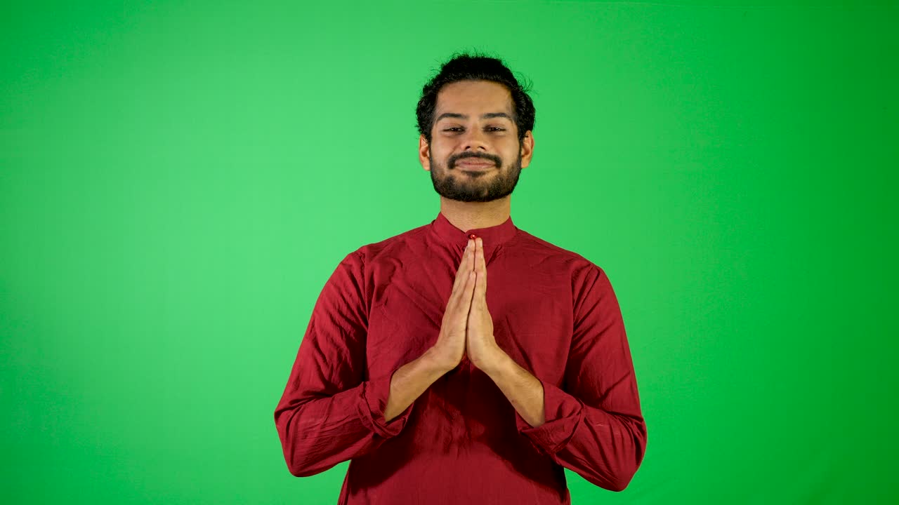 Indian guy say hello with green background - indian green background