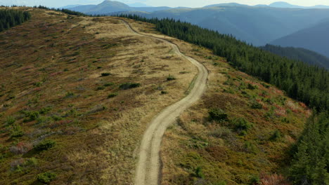 Drone-hilly-forest-path-to-peak-peaceful-touristic-national-park-sunny-day