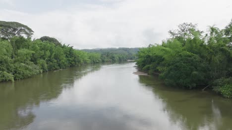 Scenic-river-flowing-through-lush-green-forest-in-Florencia,-Colombia,-serene-nature-scene