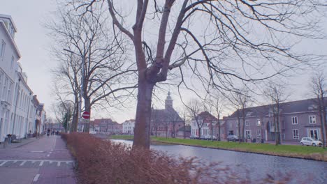 dutch water canal and buildings traditional architecture style of netherlands holland europe outside on the street walking in the city town middelburg