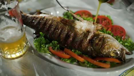 pouring sauce on fried fish