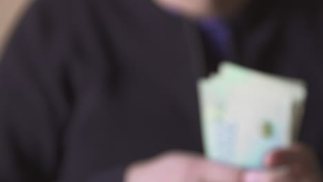 closeup of male hands counting cash sheqel israel currency paper banknotes bills paying