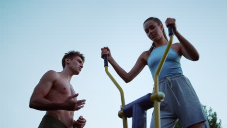 Closeup-healthy-sport-couple-training-together-in-sport-playground-outdoor.