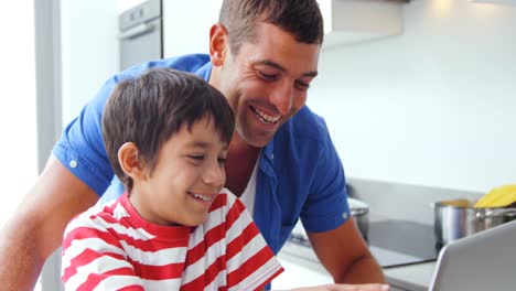 Father-and-son-using-laptop