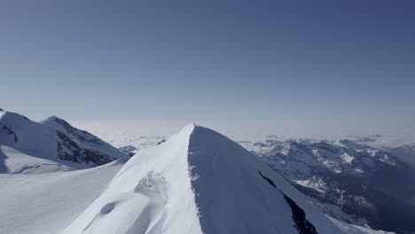 drone captures the majestic castor ridge, flying towards punta felik, revealing alpinists climbing