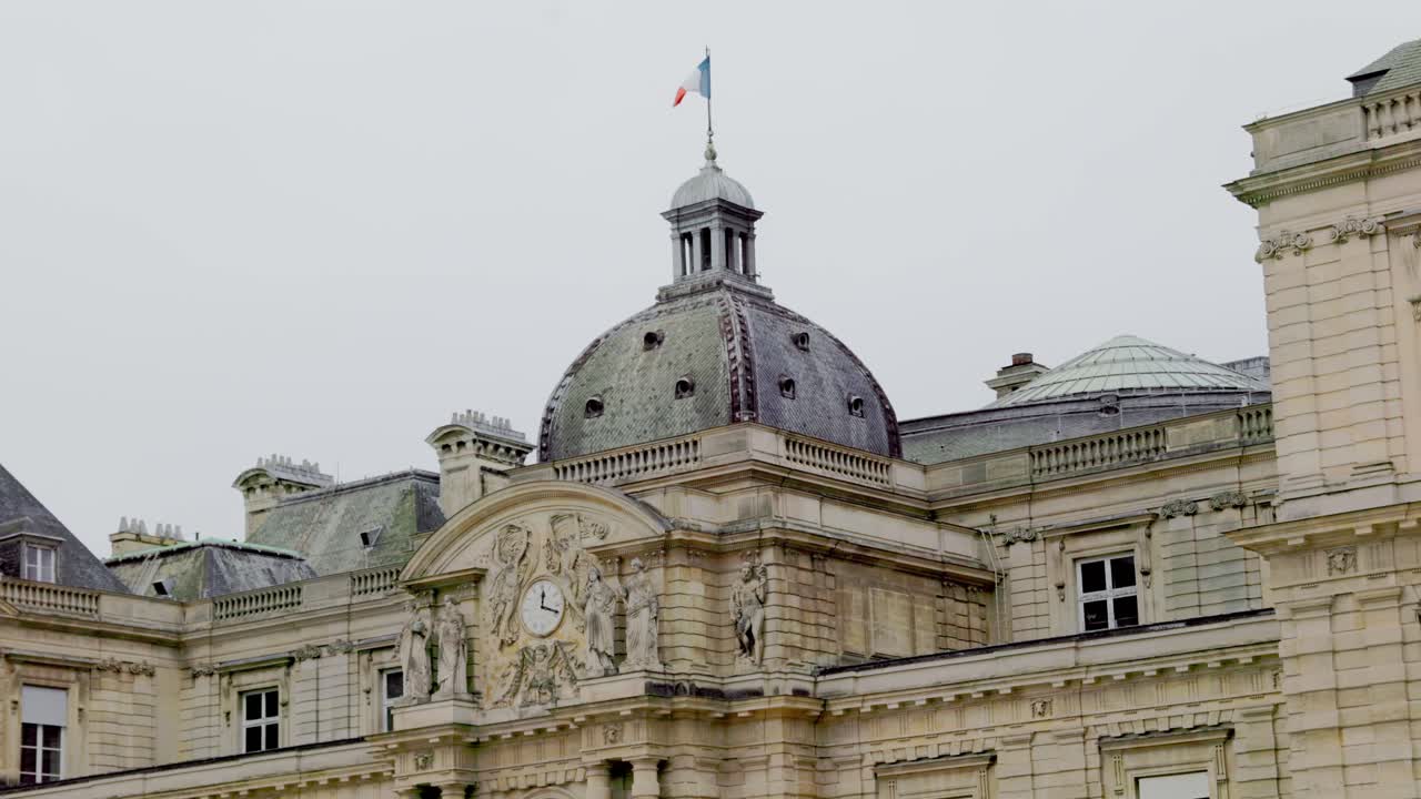 Autumn view of Paris from Luxembourg Gardens with french monument and french flag