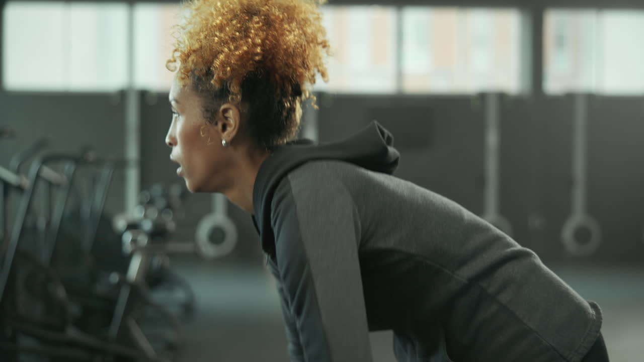 Woman lifting dumbbell in gym