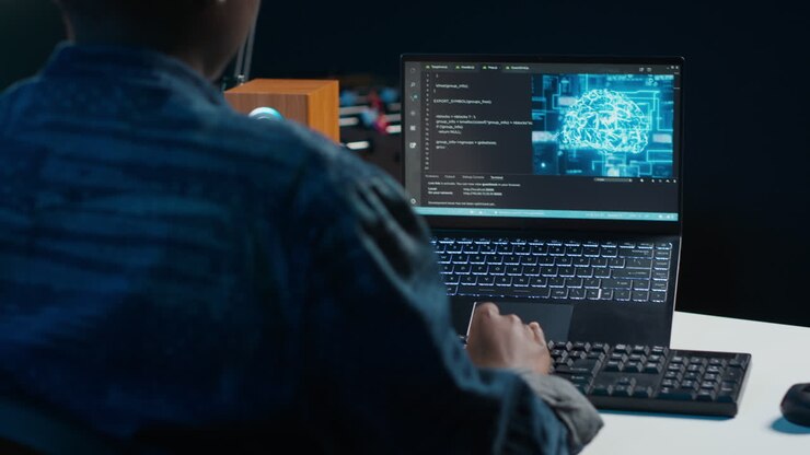 Person coding on a laptop at night
