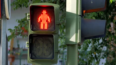 a red figure of a traffic lights turning on green figure and starts countdown until red figure reappears