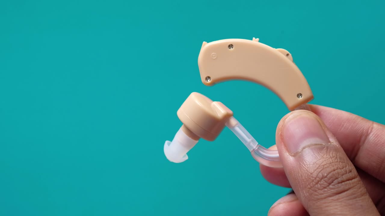 Hand Holding a Hearing Aid