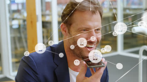 Animation of network of connections with icons over caucasian businessman talking on smartphone