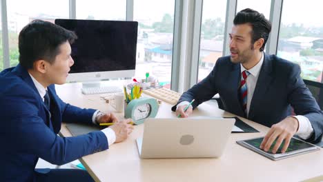 two business people talk project strategy at office