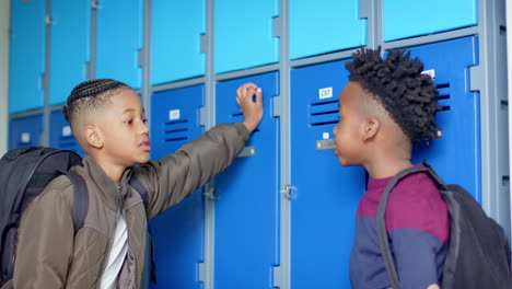 talking by school lockers, multiracial boys wearing backpacks, having conversation