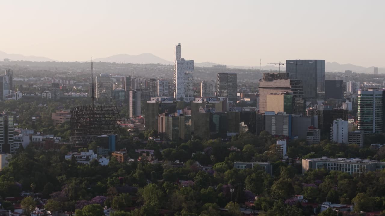 Sunset over buildings in CDMX with a parallax effect from a drone shot