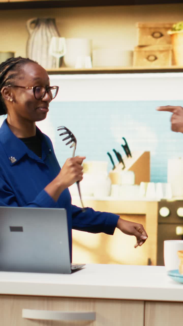 Vertical Video Overjoyed African American couple singing karaoke in the kitchen