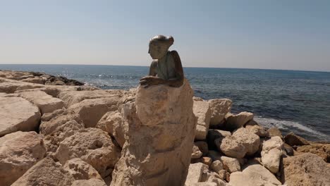 sculpture “sol alter” by yiota ioannidou. this statue sits next to the paphos coastal path near paphos fort. rocky coast and calm sea in the background, a sunny summer day in cyrpus.
