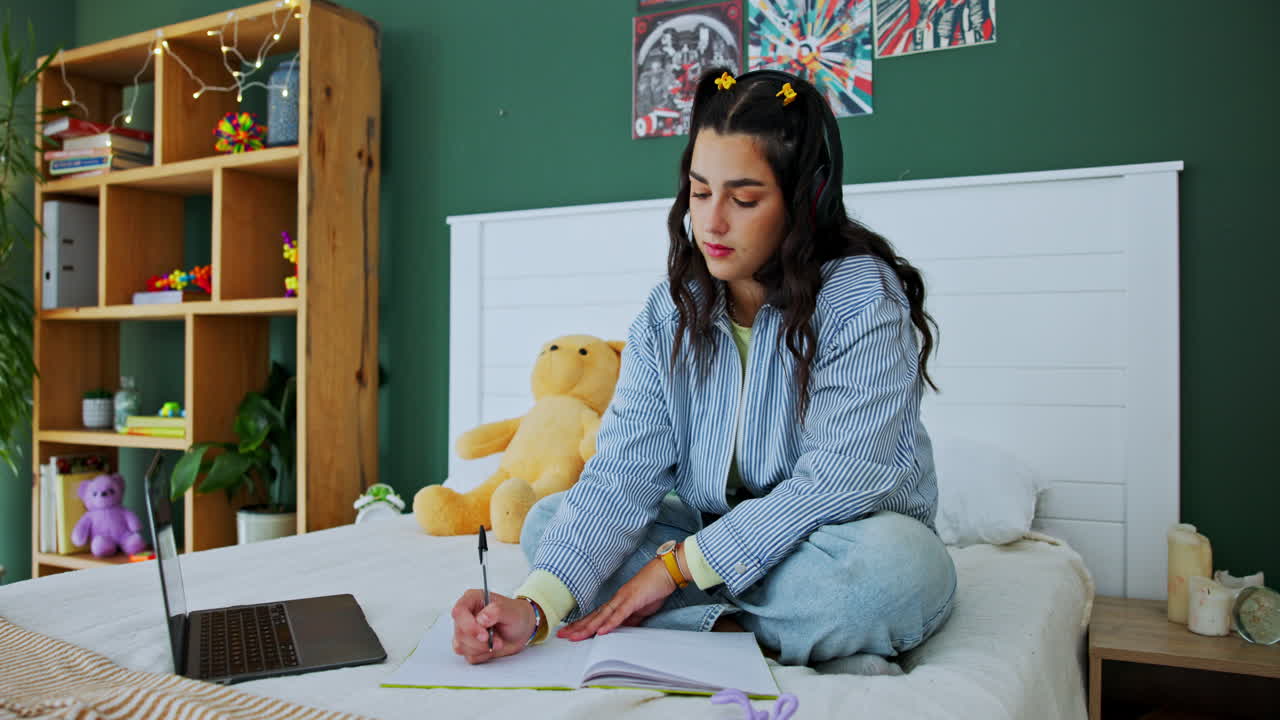 Woman studying in bedroom