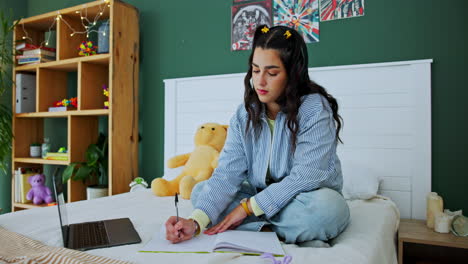 woman studying in bedroom