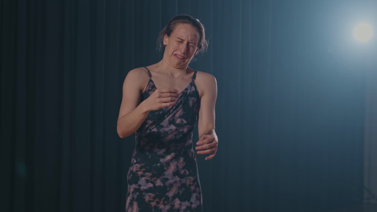 female dancer expresses deep emotions through movement and subtle hand gestures