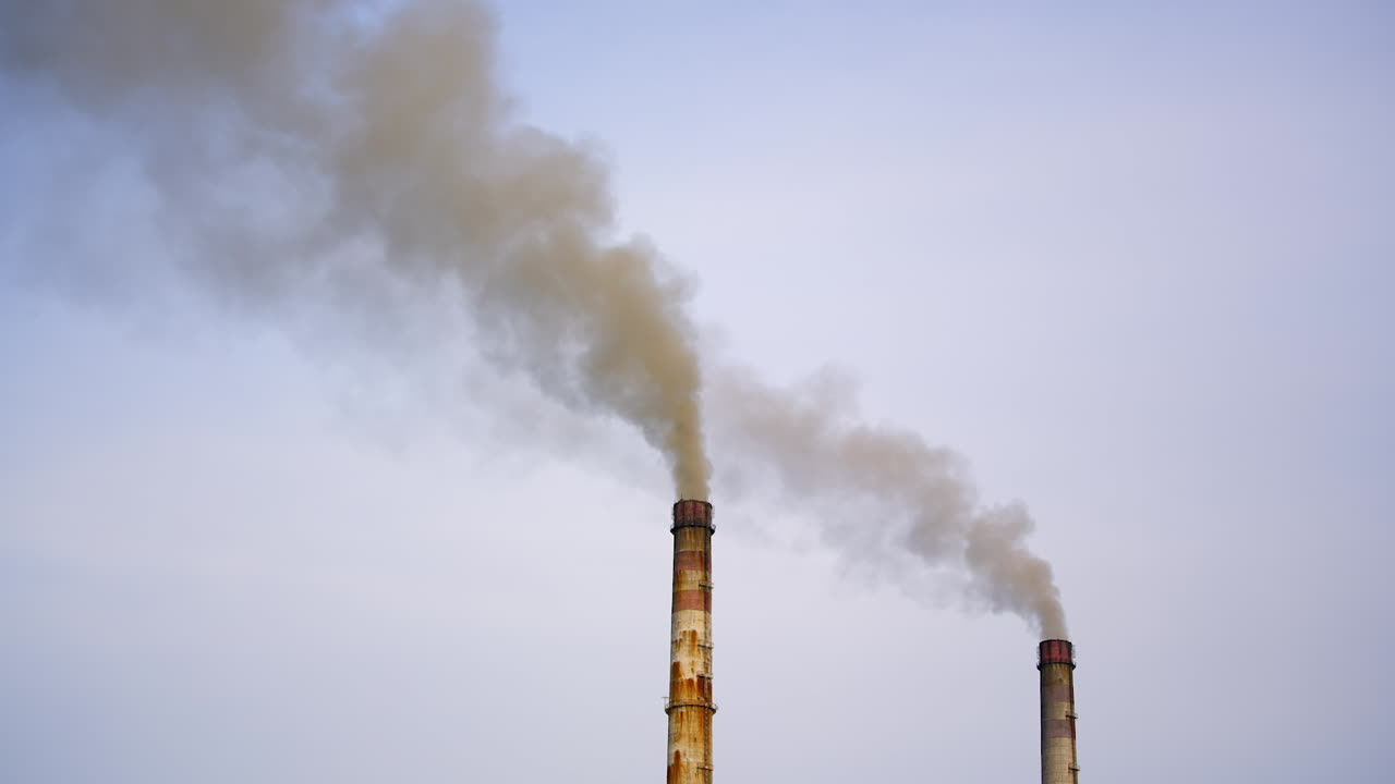 Industrial chimneys with gas and smoke. Towers with vapor from metallurgical industrial factory. Poisoned air. Pollution of nature. Toxic substances.