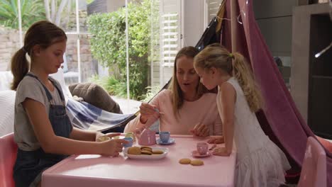 Mother-and-daughters-playing-dinette-together