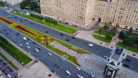 aerial view of a city street with floral design and monument