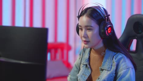 face gamer girl talking and playing video game online on computer