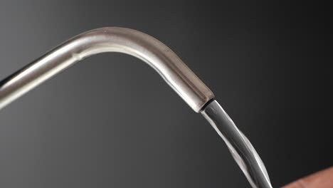 water flowing from a stainless steel faucet