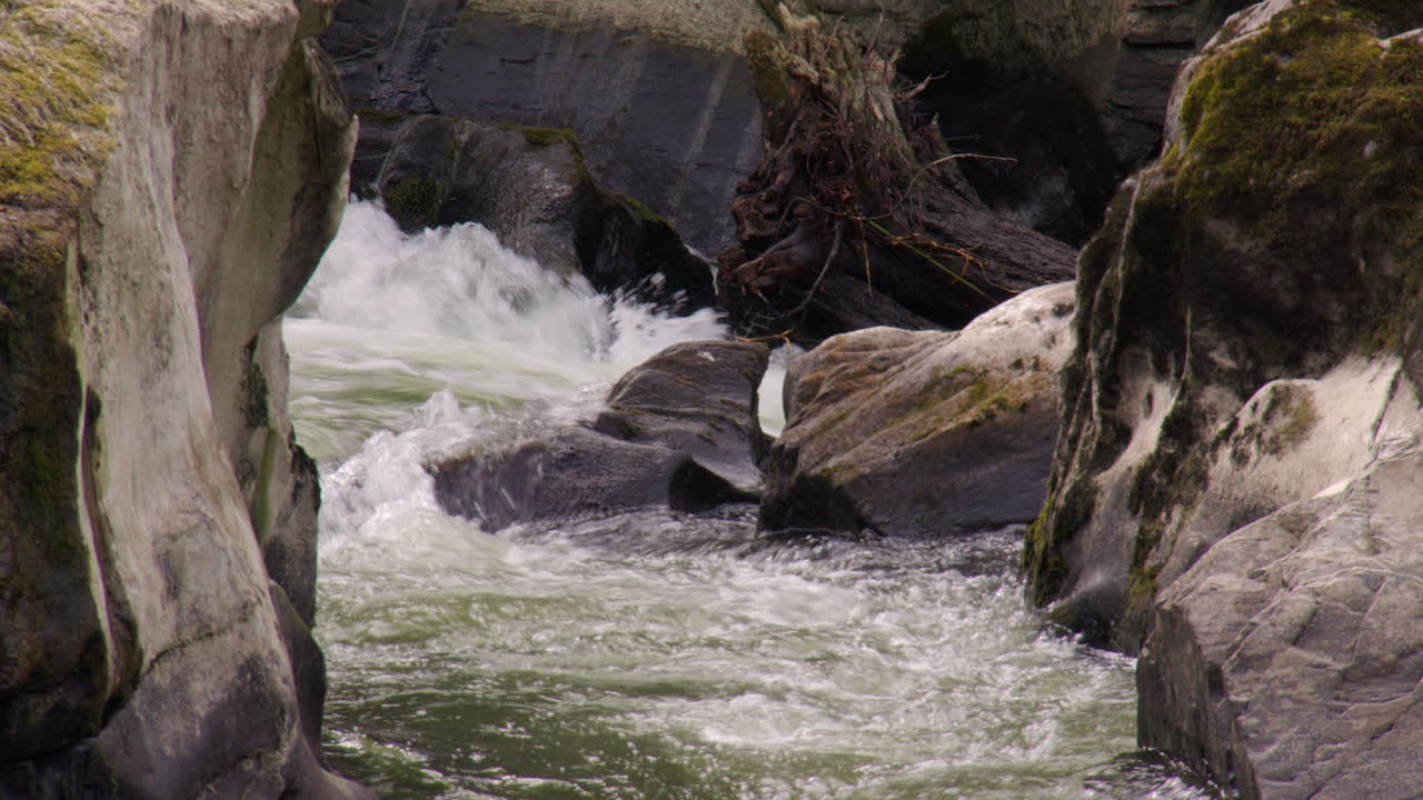 fast flowing water in between rocks at Cenarth Falls on the river Teifi